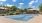 a tennis court with a fence and trees in the background