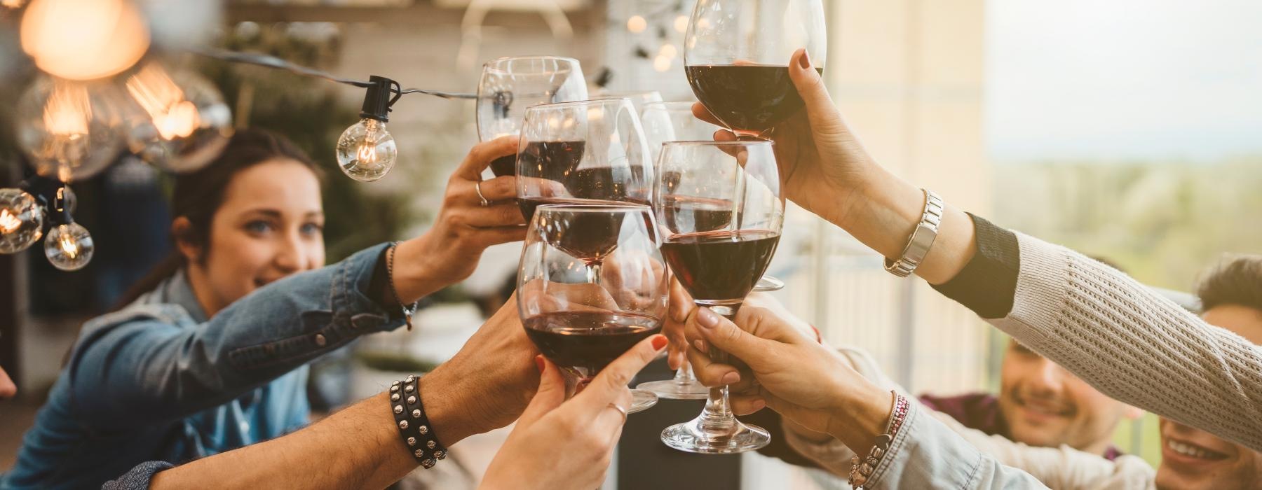 a group of people holding wine glasses