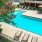 a swimming pool with chairs and umbrellas